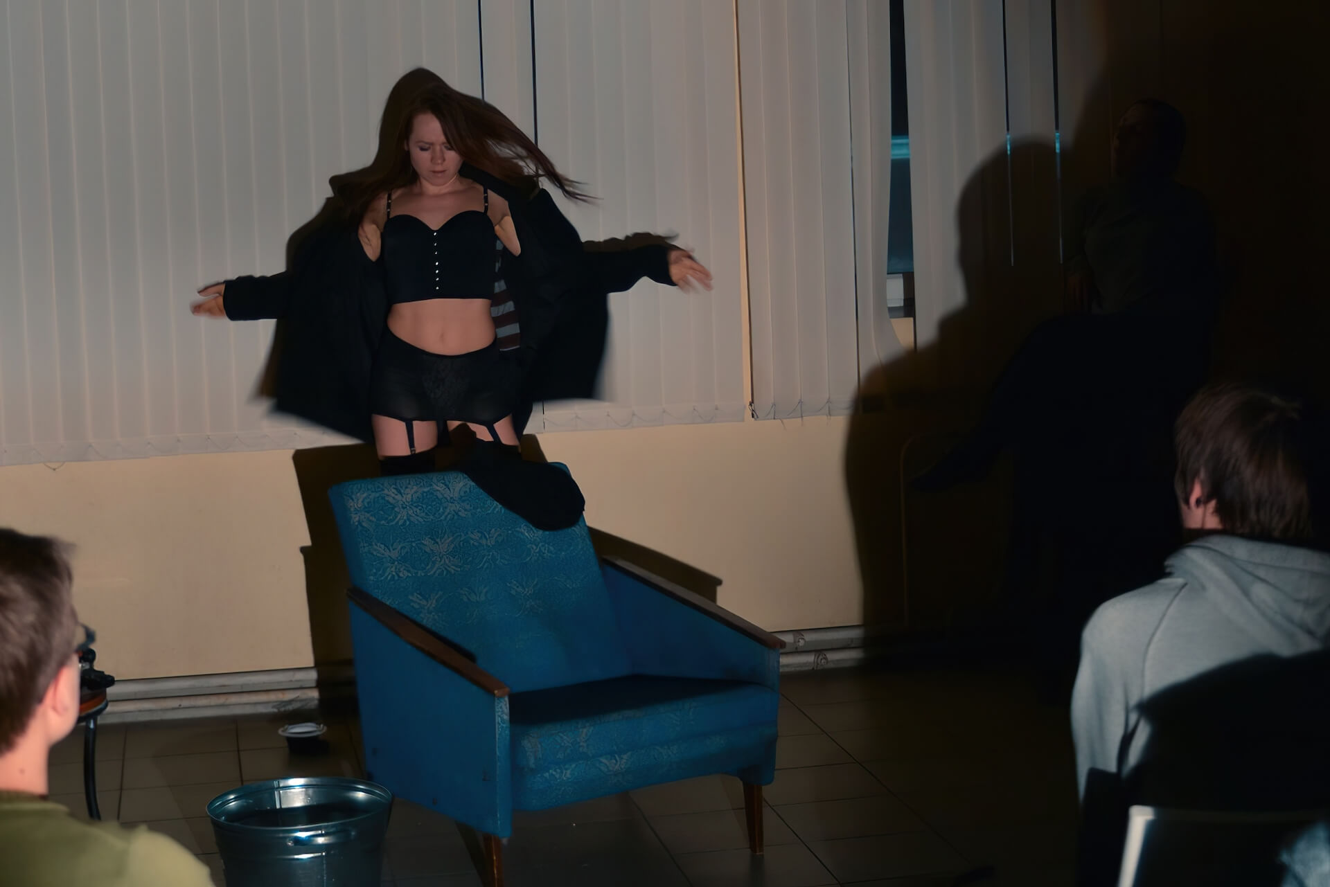 A woman taking her jacket off