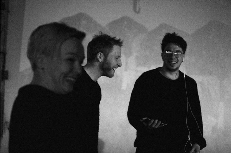 Black and white image of three people laughing